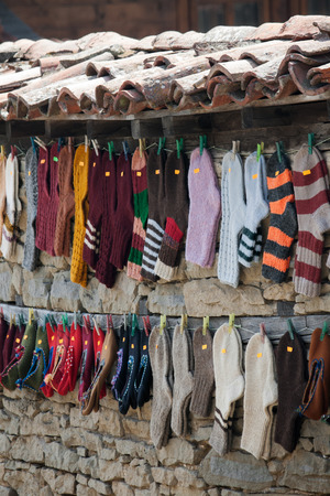 Hanging woolen socks on fence facade.の写真素材