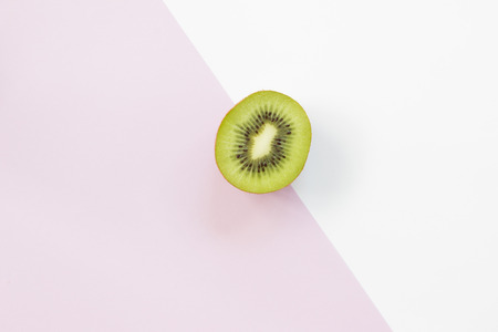 Sliced cross of  kiwi isolated on white and purple background.の写真素材