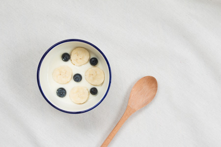 Top view of yoghurt and fresh fruit on white background.の写真素材