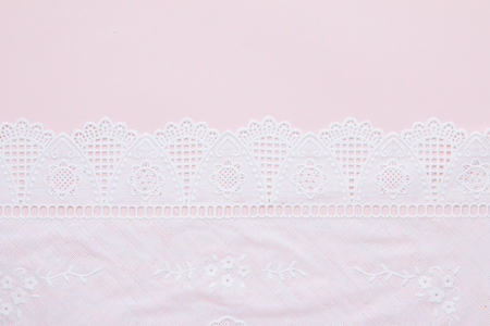 Top view of white lace pattern on pink backgroundの写真素材