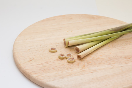 Slices of lemongrass on wooden chopping blockの写真素材