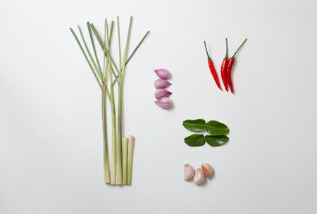 Top view of Onion, Garlic, Lemongrass, Chili, Kaffir Lime Leaves on white background.の写真素材