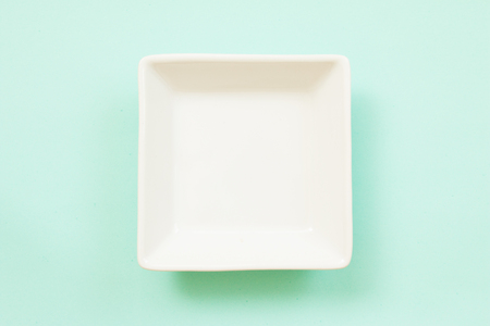 Blank white plate on blue background.
