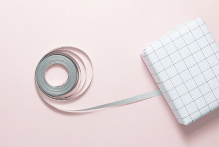 Top view of ribbon and gift box on pink background.の写真素材