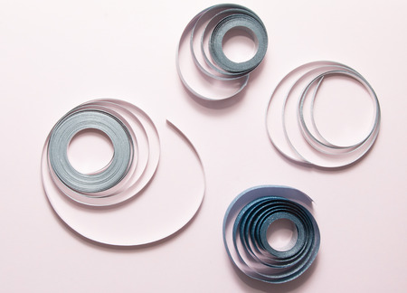 Rows of ribbon on pink background.