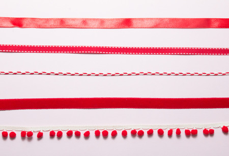 Top view of variety red ribbons on pink background.の写真素材