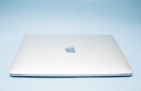 BANGKOK, THAILAND - OCTOBER 06, 2017: MacBook Pro Retina Display made by Apple Inc. on soft blue background.のeditorial素材