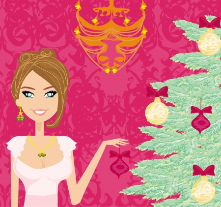 Portrait of a beautiful female hanging ornaments on a Christmas tree. のイラスト素材