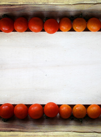 cherry tomatoes on wood - grunge frameの写真素材