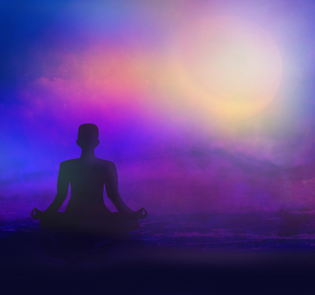 meditation on sea beach at twilightの写真素材