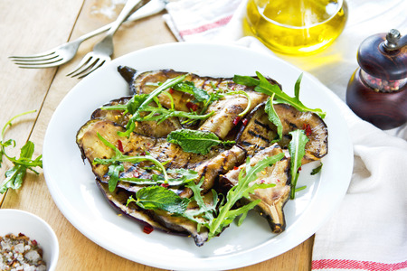 Grilled Aubergine salad with dried chili flake and Rocketの写真素材