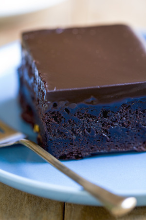 Chocolate fudge cake on a blue dishの写真素材