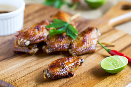 Grilled chicken wings with Thai chili sauce  and limeの写真素材