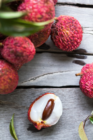 Fresh bunch of Lychees on wooden tableの写真素材