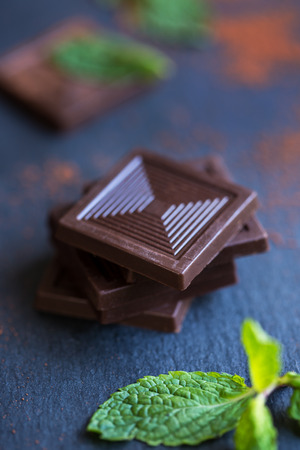 Stack of Dark Chocolate by Mint leavesの写真素材