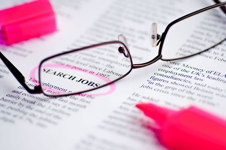 Searching job with newspaper and glasses