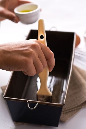 Child hands cooking, spread oilの写真素材