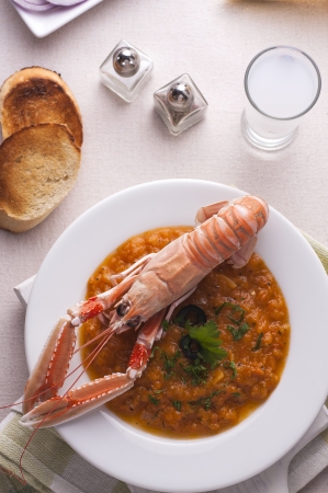 Greek style langoustine with bread and drinkの写真素材
