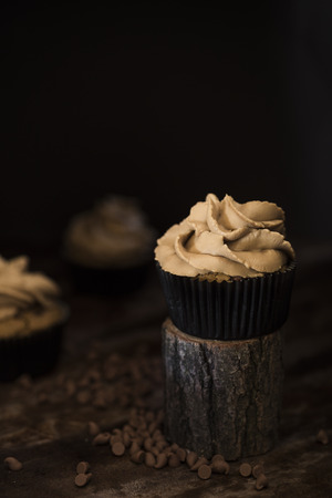 Dark chocolate cup cake with creamの写真素材