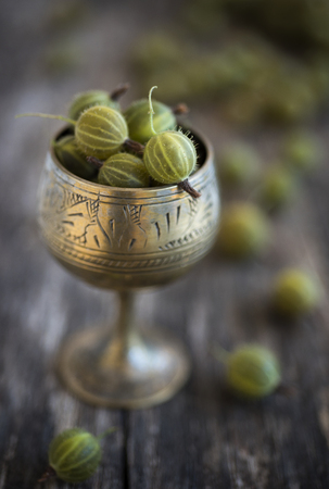 Gooseberry in old style cupの写真素材
