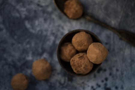 Raw cocoa truffles on blue tableの写真素材