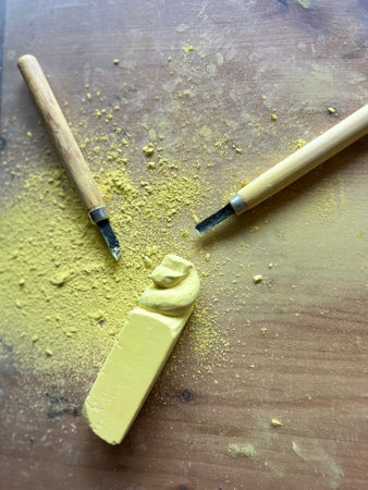 Craftsman workspace with tools and yellow chalk or stone in work.の写真素材