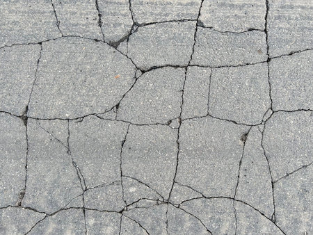 Horizontal picture of cracks smooth asphalt, broken into many small fragments. Grunge natural...