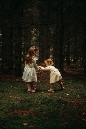 Mother and daughter playing together in the forest. Concept of friendly family.の写真素材