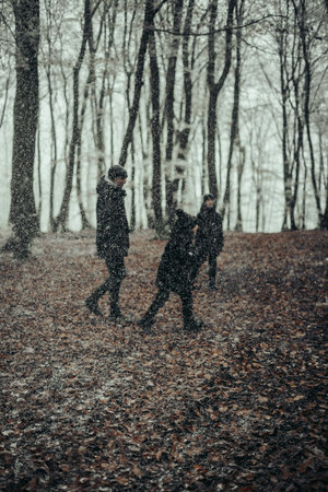 Young couple walking in the park with a dog.の写真素材