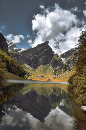 Mountain lake in the Alps with reflection of mountains in the water