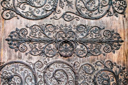 rustic metal ornaments on wooden doorの写真素材