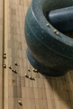mortar and pestle close up with seedsの写真素材