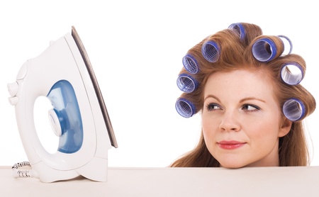 Young housewife looking at iron and doesn't know how to use it.の写真素材