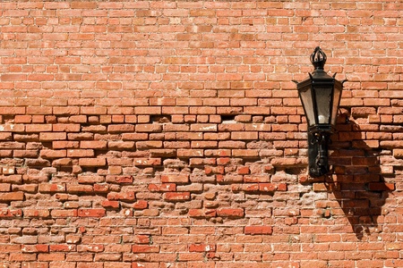 Brick wall with lamp on it の写真素材