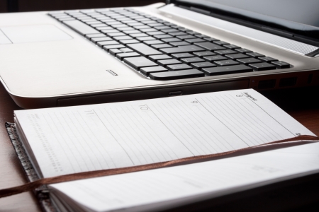 Laptop with opened planner