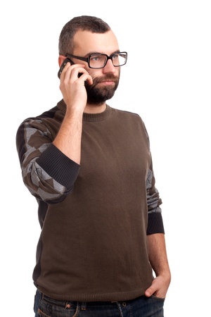 Young man with beard using cell phoneの写真素材