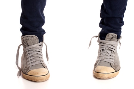 Vintage looking sneakers and ripped jeansの写真素材