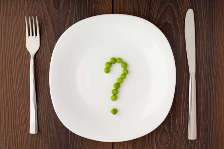 Question mark made of peas on plateの写真素材