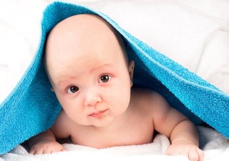 Cute baby lying on towel after showerの写真素材