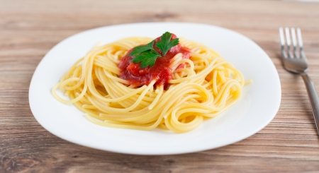 Spaghetti on a plate with tomato sauceの写真素材
