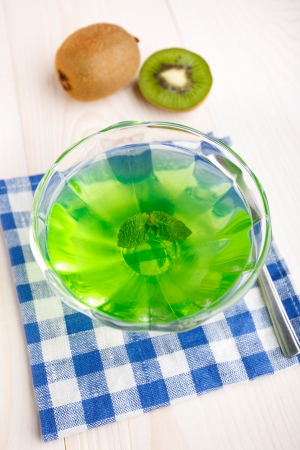 Sweet green kiwi jelly with mint leafの写真素材