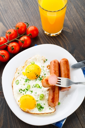Fried eggs with sausages on a plate.の写真素材