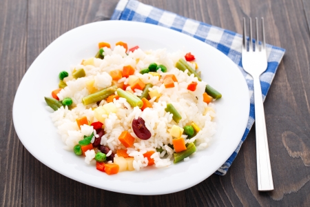 Delicious rice with vegetables on a plateの写真素材