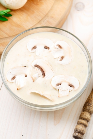 Mushroom cream soup in a bowl on a tableの写真素材