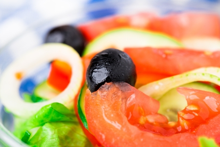 Fresh vegetable salad with tomato, onion, cucumber, paprika and olivesの写真素材