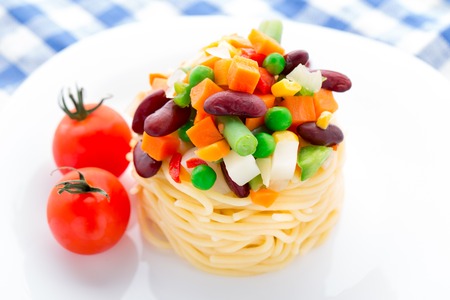 Pasta with vegetables on a white plateの写真素材