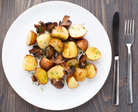 Roasted potato and mushrooms on a plateの写真素材