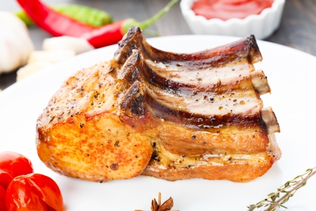 Baked pork rib chop on a plateの写真素材