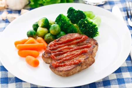 Delicious steak with vegetables on a plateの写真素材