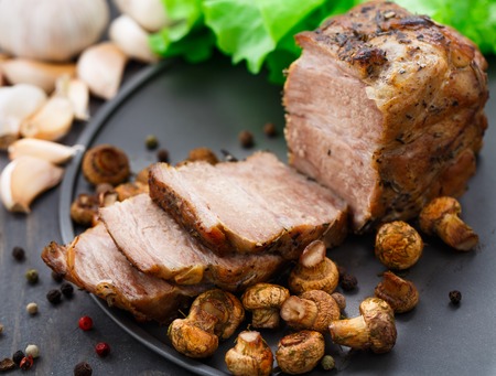 Oven baked pork with herbs and mushroomsの写真素材